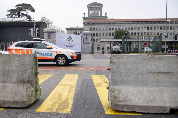 Concrete blocks and barriers are installed to protect the access to the World Trade Organization headquarters, WTO, in order to secure the premises to host the WTO12 in Geneva, Switzerland, Thursday, Nov. 25, 2021. WTO's 12th Ministerial Conference is to be held in Geneva, Switzerland, from Nov. 30 to Dec. 3, 2021. (Martial Trezzini/Keystone via AP)