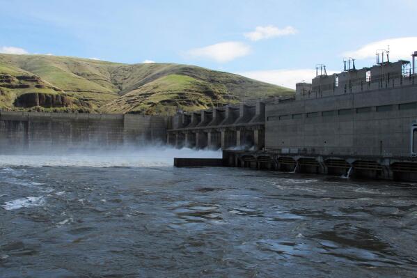FILE - Water moves through a spillway of the Lower Granite Dam on the Snake River near Almota, Wash. April 11, 2018. The benefits provided by four giant hydroelectric dams on the Snake River must be replaced before the dams can be breached to save endangered salmon runs, according to a final report issued Thursday, Aug., 25, 2022, by Washington Gov. Jay Inslee and Washington U.S. Sen. Patty Murray. (AP Photo/Nicholas K. Geranios, File)