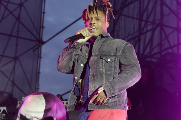 FILE - In this May 15, 2019 file photo, Juice WRLD performs in concert during his "Death Race for Love Tour" at The Skyline Stage at The Mann Center for the Performing Arts in Philadelphia. The Chicago-area rapper, whose real name is Jarad A. Higgins, was pronounced dead Sunday, Dec. 8 after a "medical emergency'' at Chicago's Midway International Airport, according to authorities. Chicago police said they're conducting a death investigation. (Photo by Owen Sweeney/Invision/AP, File)