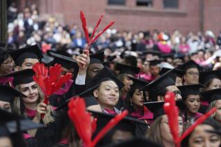 File - Harvard University students celebrate their graduate degrees in public health during Harvard commencement ceremonies, Thursday, May 25, 2023, in Cambridge, Mass. A pause on student loan payments that's been in place since the start of the COVID pandemic will end late this summer if Congress approves a debt ceiling and budget deal negotiated by House Speaker Kevin McCarthy and President Joe Biden. (AP Photo/Steven Senne, File)