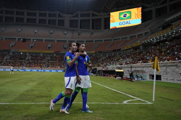 Brazil's Kaua Elias, right, celebrates with teammate Brazil's Dudu after scoring a goal during the FIFA U-17 World Cup Group C soccer match between Brazil and England at Jakarta International Stadium in Jakarta, Indonesia, Friday, Nov. 17, 2023. (AP Photo/Achmad Ibrahim)