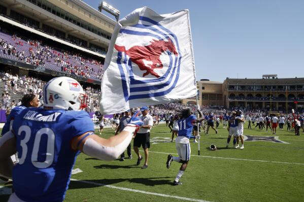 SMU wide receiver Rashee Rice (11), followed by linebacker Brian Holloway (30) runs the SMU flag to midfield after they defeated TCU a NCAA football game in Fort Worth, Texas, Saturday, Sept. 25, 2021. (AP Photo/Michael Ainsworth)