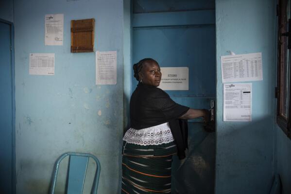 Mariama Sawadogo, 44, arrives at her works as a radio host at Zama Radio, in Kaya, Burkina Faso, Monday, Oct. 25, 2021. Many guests and listeners in Burkina Faso call her "aunty" as she gently guides them to the right answers and awards prizes such as soap and washing buckets. In the West African country of Burkina Faso, many feel the government has let them down during the pandemic. Tests, vaccines and messaging often miss many residents, despite a $200 million budget for virus-response efforts. In a region where women are responsible for family work and community relationships, they’ve stepped up to fill in gaps. (AP Photo/Sophie Garcia)