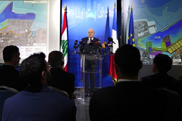 Lebanese caretaker Prime Minister Najib Mikati, center, speaks during a conference announcing a French reconstruction plan for the Beirut Port, in Beirut, Lebanon, Wednesday, March 13, 2024. Three and a half years after hundreds of tons of improperly stored ammonium nitrate ignited at the Beirut port, setting off one of the world's biggest non-nuclear explosions, Lebanese and French officials put forward a plan for reconstruction and reorganization of the port Wednesday. (AP Photo/Bilal Hussein)