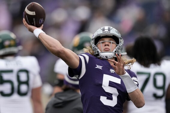 FILE - Kansas State quarterback Avery Johnson throws before an NCAA college football game against Baylor Saturday, Nov. 11, 2023, in Manhattan, Kan. Johnson will be taking over for Will Howard, who transferred to Ohio State. (AP Photo/Charlie Riedel, File)