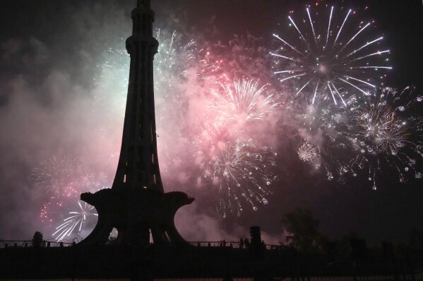 Fireworks light the sky close to the Minar-e-Pakistan or Pakistan monument during the Pakistan Independence Day celebrations, in Lahore, Pakistan, Wednesday, Aug. 14, 2024. (AP Photo/K.M. Chaudary)