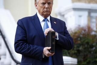 FILE- In this June 1, 2020, file photo President Donald Trump holds a Bible as he visits outside St. John's Church across Lafayette Park from the White House in Washington. (AP Photo/Patrick Semansky, File)