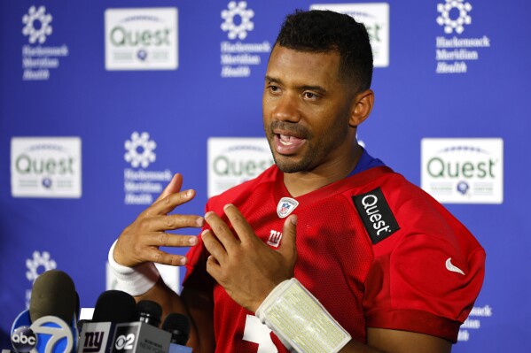 New York Giants quarterback Russell Wilson talks to reporters after NFL football practice in East Rutherford, N.J., Thursday, June 5, 2025. (AP Photo/Noah K. Murray)