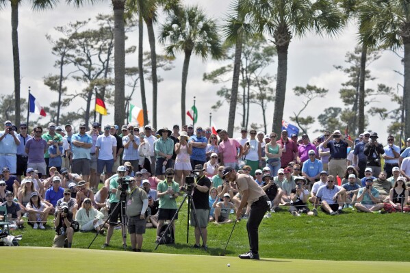 Xander Schauffele hits his putt on the second hole during the final round of The Players Championship golf tournament Sunday, March 17, 2024, in Ponte Vedra Beach, Fla. (AP Photo/Lynne Sladky)