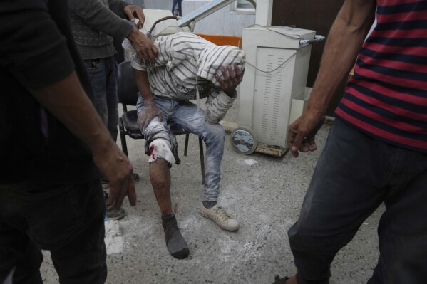 A Palestinian, who was injured last night while trying to get access to humanitarian aid, waits to be treated at the al-Shifa Hospital, in Gaza City, Wednesday, June 11, 2025. (AP Photo/Jehad Alshrafi)