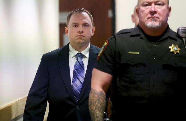 Aaron Dean arrives to the 396th District Court in Fort Worth on Monday, Dec. 5, 2022, in Fort Worth, Texas, for the first day of his trial in the murder of Atatiana Jefferson. Dean, a former Fort Worth police officer, is accused of fatally shooting Jefferson in 2019. (Amanda McCoy/Star-Telegram via AP, Pool)