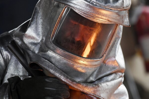 
              FILE - In this Jan. 9, 2018 file photo, molten bronze metal is reflected in the mask of a worker as he pours it into molds during the 24th Annual Casting of the Screen Actors Guild Statuette at American Fine Arts Foundry in Burbank, Calif. The SAG Awards will be held on Sunday, Jan. 21 in Los Angeles. (Photo by Chris Pizzello/Invision/AP)
            