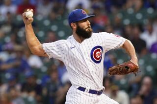 Chicago Cubs starting pitcher Jake Arrieta throws to a Milwaukee Brewers batter during the first inning of a baseball game in Chicago, Wednesday, Aug. 11, 2021. (AP Photo/Nam Y. Huh)