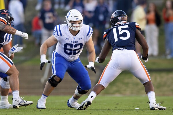 FILE - Duke offensive lineman Graham Barton (62) blocks Virginia defensive end Chico Bennett Jr. (15) during the an NCAA college football game Nov. 18, 2023, in Charlottesville, Va. The Tampa Bay Buccaneers selected Barton in the first round of the NFL draft Thursday, April 25. (AP Photo/Mike Caudill, File)