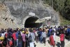 People watch rescue and relief operations at the site of an under-construction road tunnel that collapsed in India's mountainous Uttarakhand state, Wednesday, November 15, 2023. Rescuers are trying to dig wide pipes through the excavated rubble to create a passage to free it. 40 construction workers have been trapped since Sunday. A landslide on Sunday caused part of the 4.5-kilometer (2.7-mile) tunnel to collapse about 200 meters (500 feet) from the entrance. It is a mountainous area prone to landslides and subsidence. (AP photo)