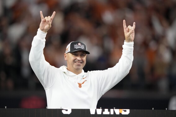 FILE - Texas head coach Steve Sarkisian celebrates after his team won the Big 12 Conference championship NCAA college football game against Oklahoma State in Arlington, Texas, Saturday, Dec. 2, 2023. Sarkisian’s contract extension will push his guaranteed salary to $10.3 million this year under details released by the school's Board of Regents. That will make him one of the highest paid coaches in the country after leading the Longhorns to the Big 12 championship and their first appearance in the College Football Playoff. (AP Photo/Tony Gutierrez, File)