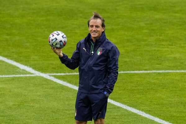 FILE - Italy's manager Roberto Mancini smiles during a training session at the Hive stadium in London, England, on July 5, 2021. Italy coach Roberto Mancini resigned surprisingly on Sunday, Aug. 13, 2023, ending an an up-and-down tenure with the national team that included a European Championship title in 2021 but also a failed qualification for last year’s World Cup. (AP Photo/Matt Dunham)
