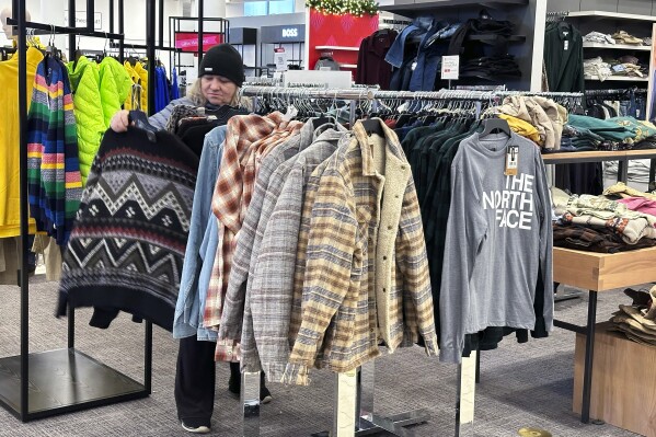 A shopper looks at outerwear at a store in Schaumburg, Ill., Monday, Dec. 18, 2023. On Wednesday, the Commerce Department releases U.S. retail sales data for December. (AP Photo/Nam Y. Huh)