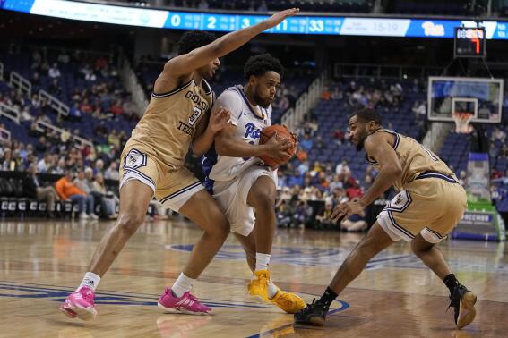 Pittsburgh guard Nelly Cummings drives between Georgia Tech guard Dallan Coleman and guard Kyle Sturdivant during the second half of an NCAA college basketball game at the Atlantic Coast Conference Tournament, Wednesday, March 8, 2023, in Greensboro, N.C. (AP Photo/Chris Carlson)