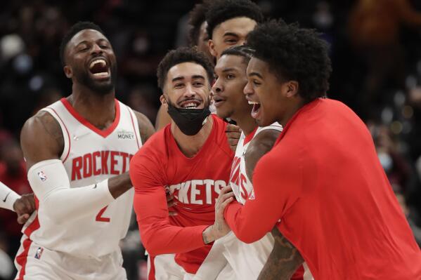 Houston Rockets' Kevin Porter Jr., second from right, celebrates with teammates after making the game-winning 3-point shot in the team's NBA basketball game against the Washington Wizards, Wednesday, Jan. 5, 2022, in Washington. (AP Photo/Luis M. Alvarez)