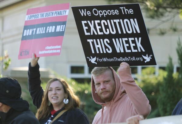 FILE - Mirabai Hull, left, and Matthew Harris protest against the death penalty and the execution of Benjamin Cole outside of the Oklahoma Governor's Mansion on Oct. 20, 2022, in Oklahoma City. Public support and use of the death penalty in 2022 continued its more than two-decade long decline in the U.S., and many of the executions that were carried out were “botched” or highly problematic, according to an annual report on capital punishment released Friday, Dec. 16. (Doug Hoke/The Oklahoman via AP, File)