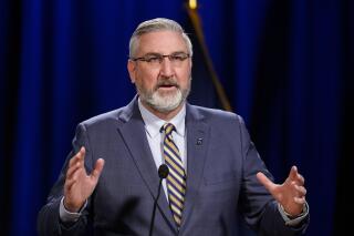 FILE - In this Jan. 19, 2021 file photo, Indiana Gov. Eric Holcomb delivers his State of the State address virtually, in Indianapolis. Indiana's attorney general Todd Rokita took aim Friday, May 1, 2021, at Gov. Holcomb's attempt to block a new law giving state legislators more authority to intervene during public emergencies declared by the governor. A lawsuit filed by the Republican governor on Tuesday, April 27, 2001, challenged the law enacted over his veto two weeks ago giving legislative leaders the power to call the General Assembly into what it calls an "emergency session." (AP Photo/Darron Cummings File)