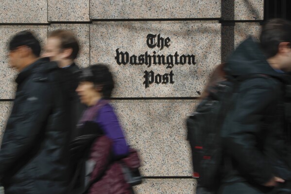 People walk by the One Franklin Square Building, home of The Washington Post newspaper, in downtown Washington, Feb. 21, 2019. (AP Photo/Pablo Martinez Monsivais, File)