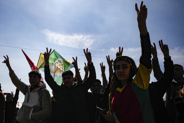FILE - Supporters of pro-Kurdish Peoples' Equality and Democracy Party (DEM Party) chant slogans during the Newroz celebrations, in Istanbul, Turkey, on March 17, 2024. A Turkish court on Thursday, May 16, 2024 sentenced dozens pro-Kurdish politicians to between nine and 30 years in prison over riots in 2014 by Kurds angered at what they perceived to be the government's inaction against Islamic State group militants who had besieged the Syrian border town of Kobane, state media reported. (AP Photo/Emrah Gurel, File)