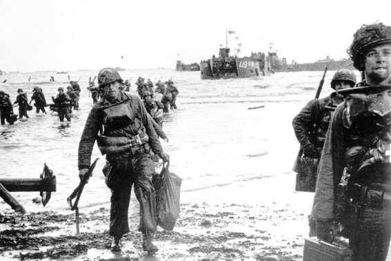 FILE - Carrying full equipment, American assault troops move onto a beachhead code-named Omaha Beach, on the northern coast of France on June 6, 1944, during the Allied invasion of the Normandy coast. The greatest armada ever assembled, nearly 7,000 ships and boats, supported by more than 11,000 planes, carried almost 133,000 troops across the Channel to establish toeholds on five heavily defended beaches stretched across 80 kilometers (50 miles) of Normandy coast. More than 9,000 Allied soldiers were killed or wounded in the first 24 hours. (U.S. Army via AP, File)