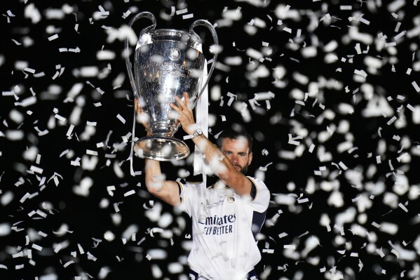 CORRECTS NAME OF PLAYER - Real Madrid's Nacho holds the Champions League trophy at the Cibeles square during a trophy parade in Madrid, Spain, Sunday, June 2, 2024. Real Madrid won against Borussia Dortmund 2-0. (AP Photo/Bernat Armangue)