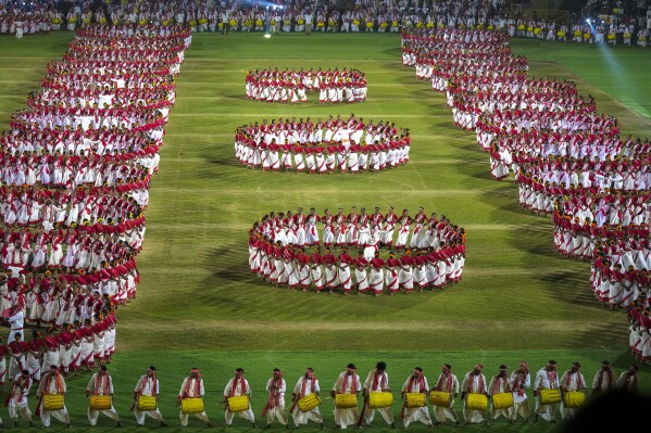 Tribal youth perform Jhumur dance during a dance event attempting a world record in Guwahati, India, Monday, Feb. 24, 2025. (AP Photo/Anupam Nath)