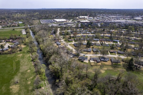 FILE - Coldwater Creek flows Friday, April 7, 2023, in Florissant, Mo. Democratic U.S. Rep. Cori Bush and several people who grew up along a contaminated St. Louis County creek on Friday, April 5, 2024, urged the U.S. House to pass a measure that would provide compensation for those whose illnesses are believed to be connected to nuclear contamination. Coldwater Creek was contaminated decades ago when waste from nuclear bomb development was dumped into the creek. (AP Photo/Jeff Roberson, File)