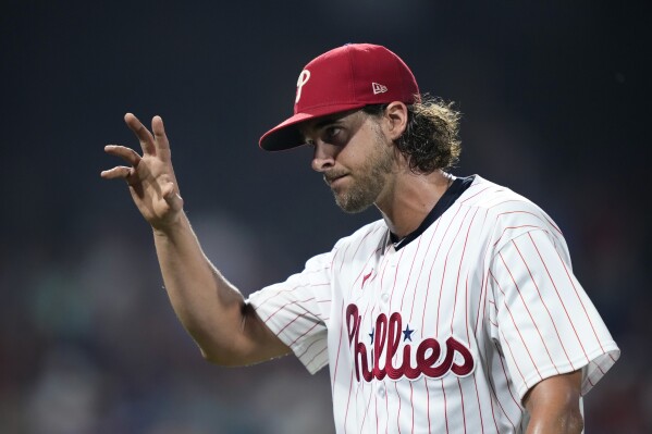Philadelphia Phillies pitcher Aaron Nola waves to the crowd after being pulled during the eighth inning of a baseball game against the Milwaukee Brewers, Tuesday, July 18, 2023, in Philadelphia. (AP Photo/Matt Slocum)