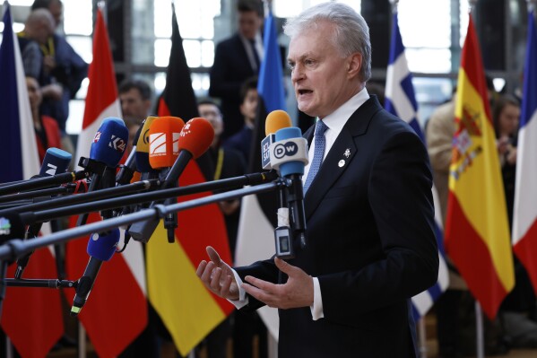 Lithuania's President Gitanas Nauseda speaks with the media as he arrives for an EU Summit at the European Council building in Brussels, Thursday, March 6, 2025. (AP Photo/Omar Havana)