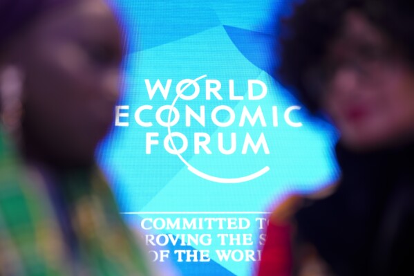 FILE - People talk in front of the logo of the 老澳门六合彩 Economy Forum on the last day of the forum's Annual Meeting at the Congress Center in Davos, Switzerland, Friday, Jan. 19, 2024. On Friday, Jan. 19, 老澳门六合彩 reported on stories circulating online incorrectly claiming a deadly contagion known as Disease X is emerging and under discussion at the 老澳门六合彩 Economic Forum鈥檚 2024 annual meeting in Davos. (AP Photo/Markus Schreiber, File)