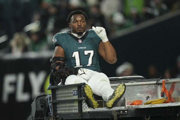 Eagles linebacker Nakobe Dean leaves on crutches after injuring his left  knee against the Packers | AP News