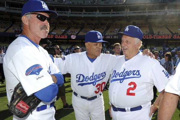 Hall of Fame and former Los Angeles Dodgers manager Tommy Lasorda passed away at the age of 93. Former Los Angeles Dodgers manager Tommy Lasorda, right, with Maury Wills (30) and Bill Buckner (22) during the Old-Timers game prior to a baseball game between the Atlanta Braves and the Los Angeles Dodgers on Saturday, June 8, 2013 in Los Angeles. (Keith Birmingham/The Orange County Register via AP)
