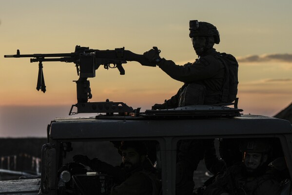 An Israeli soldier takes up position on the border with the Gaza Strip in southern Israel, Monday, Jan. 29, 2024. U.S. and Mideast mediators appeared optimistic in recent days that they are closing in on a deal for a two-month cease-fire in Gaza and the release of over 100 hostages held by Hamas. But on Tuesday, Israeli Prime Minister Benjamin Netanyahu rejected the militant group's two main demands — that Israel withdraw its forces from Gaza and release thousands of Palestinian prisoners — indicating that the gap between the two sides remains wide. (AP Photo/Tsafrir Abayov)