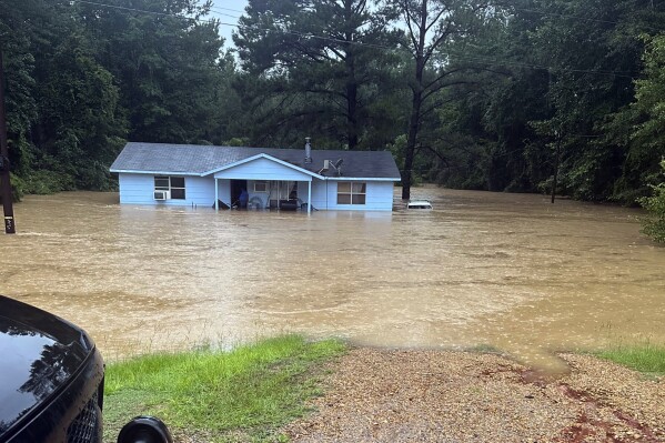 In this image provided by Mississippi state Rep. Michael Evans, floodwaters surround a home in Louisville, Miss., Thursday, July 13, 2023. Flash flooding was also reported Thursday in Winston, Choctaw, Neshoba and Noxubee counties. (Mississippi state Rep. Michael Evans via the AP)