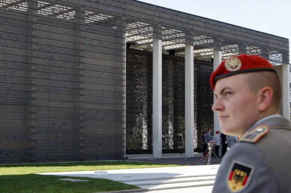 FILE - A soldier is seen in front of the 'Military Memorial of the German Bundeswehr' in Berlin Germany, Tuesday, Sept. 8, 2009. The German parliament voted Thursday for the introduction of an annual national “veterans' day” to honor the service of people who have served in the military, which often has struggled to gain recognition in the country. (AP Photo/Michael Sohn, File)