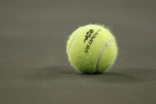 FILE = A tennis ball on the court during the first round of the U.S. Open tennis tournament in New York, Tuesday, Aug. 30, 2011. Casey Kania, an American tennis player who competed for the University of North Carolina, was suspended for two years after testing positive for marijuana during an ATP Challenger tournament in August 2023, the International Tennis Integrity Agency announced Tuesday, Feb. 27, 2024. (AP Photo/Charles Krupa, File)