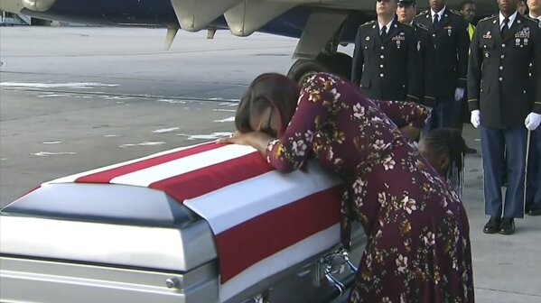 
              ADDS TRUMP'S RESPONSE TO REP. WILSON - In this Tuesday, Oct. 17, 2017, frame from video, Myeshia Johnson cries over the casket of her husband, Sgt. La David Johnson, who was killed in an ambush in Niger, upon his body's arrival in Miami. President Donald Trump told the widow that her husband "knew what he signed up for," according to Rep. Frederica Wilson, who said she heard part of the conversation on speakerphone. In a Wednesday morning tweet, Trump said Wilson's description of the call was "fabricated." (WPLG via AP)
            