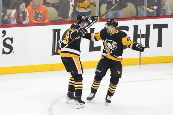 Pittsburgh Penguins' Dominik Simon, left, celebrates a goal by