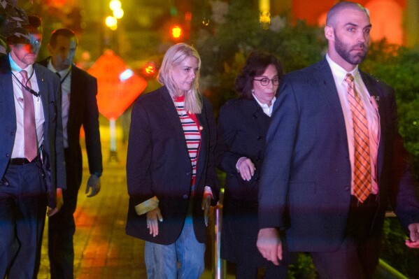 Attorney General Pam Bondi, center, and U.S. Attorney for the District of Columbia Jeanine Pirro, second right, walk to cars as law enforcement work the scene after two staff members of the Israeli Embassy in Washington were shot and killed outside the Capital Jewish Museum, Thursday, May 22, 2025, in Washington. (AP Photo/Rod Lamkey, Jr.)