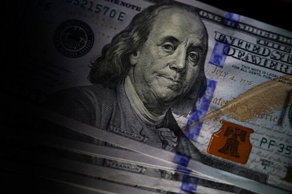 FILE - The likeness of Benjamin Franklin is seen on U.S. $100 bills, July 14, 2022, in Marple Township, Pa. In 2023, the Federal Trade Commission received over 64,000 romance scams reports that translated into $1.14 billion in reported losses. (APPhoto/Matt Slocum, File)