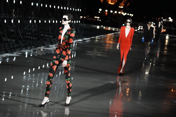 Models wear creations for Saint Laurent Spring-Summer 2022 ready-to-wear fashion show presented Tuesday, Sept. 28, 2021, in Paris. (AP Photo/Thibault Camus)