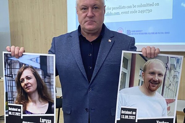 In this handout photo from the Viasna Human Rights Center, Leanid Sudalenka, an activist from Belarus, holds portraits of imprisoned journalists Larysa Shchyrakova and Yauhen Merkis, in Belostok, Poland, Sunday, Nov. 5, 2023. Sudalenka, who was imprisoned for three years in Belarus, said authorities there hold political prisoners in conditions amounting to "torture." He told The Associated Press that when he was in a Belarusian penal colony, he nearly died from COVID-19 and a lack of medical care. (Viasna Human Rights Center via AP)