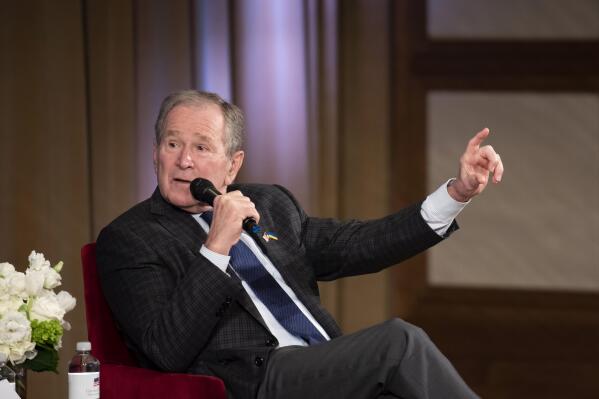 Former President George W. Bush speaks with David Kramer, the Executive Director of the George W. Bush Institute, during "The Struggle for Freedom" event at the George W. Bush Presidential Center in Dallas, Wednesday, Nov. 16, 2022. (AP Photo/Emil Lippe)