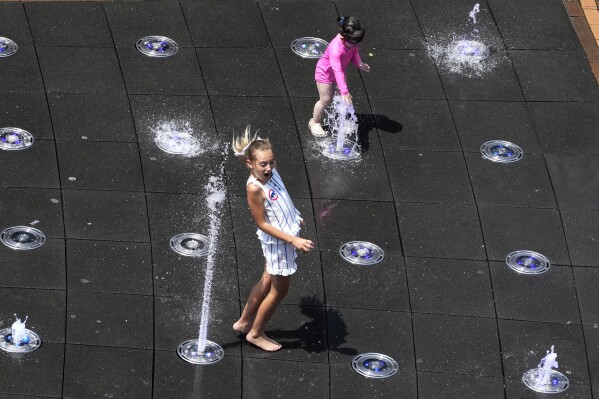 Children cool off at the fountain at Gallagher Way Park on a hot day in Chicago, Sunday, June 16, 2024. (AP Photo/Nam Y. Huh)