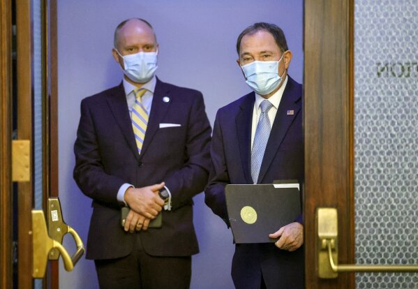 Chief of Staff Justin Harding, left, stands behind Utah Gov. Gary Herbert before a press conference at the Capitol in Salt Lake City, clarifying the state's mask mandate on Monday, Nov. 9, 2020. (Scott G Winterton/The Deseret News via AP, Pool)